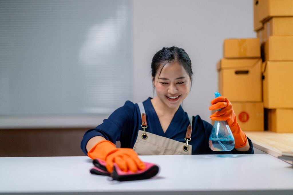 smiling cleaner using spray and cloth on a white t 2025 07 05 06 18 29 utc 1 scaled